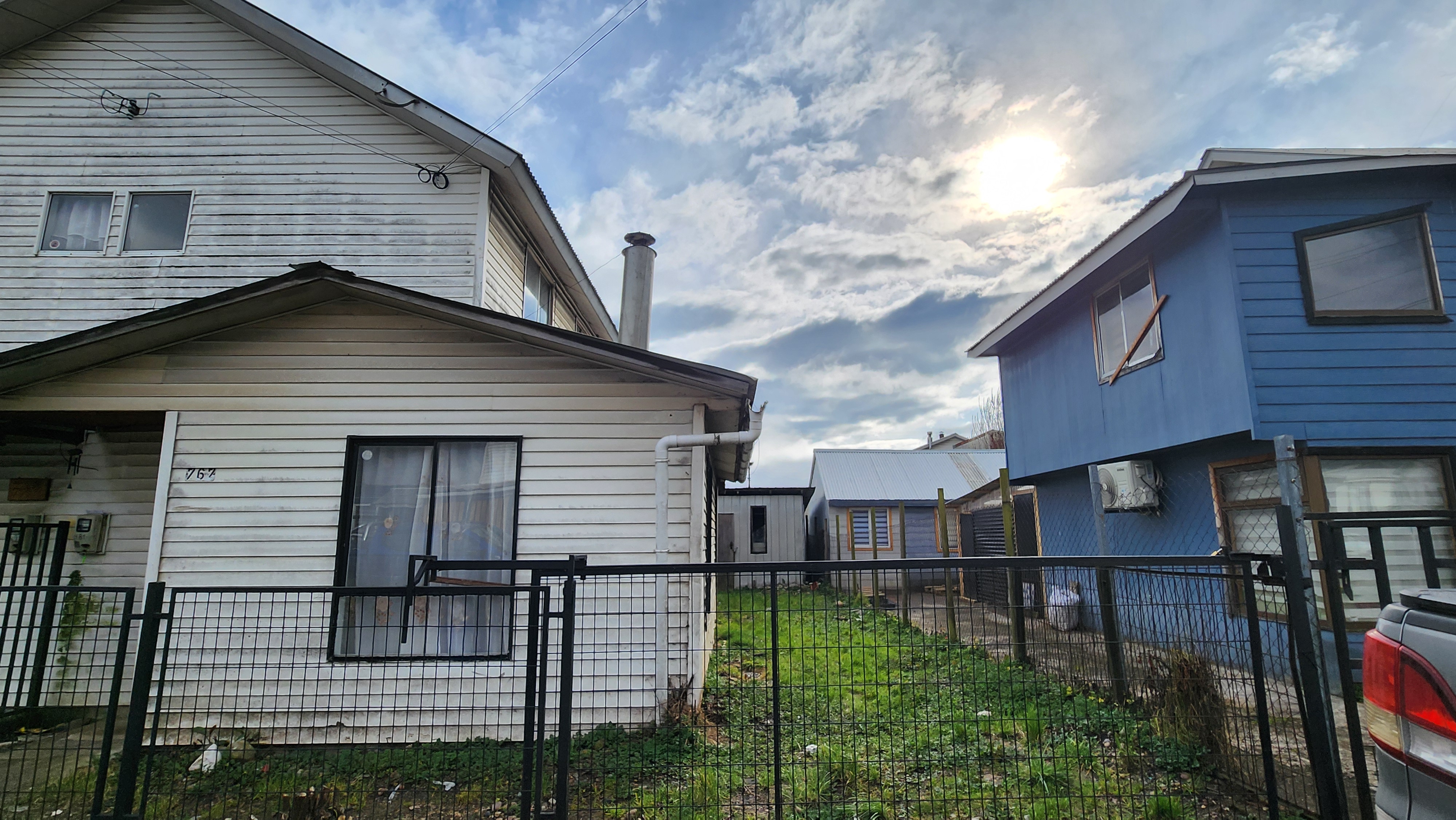 View of the backyard with trees and potential garden space.