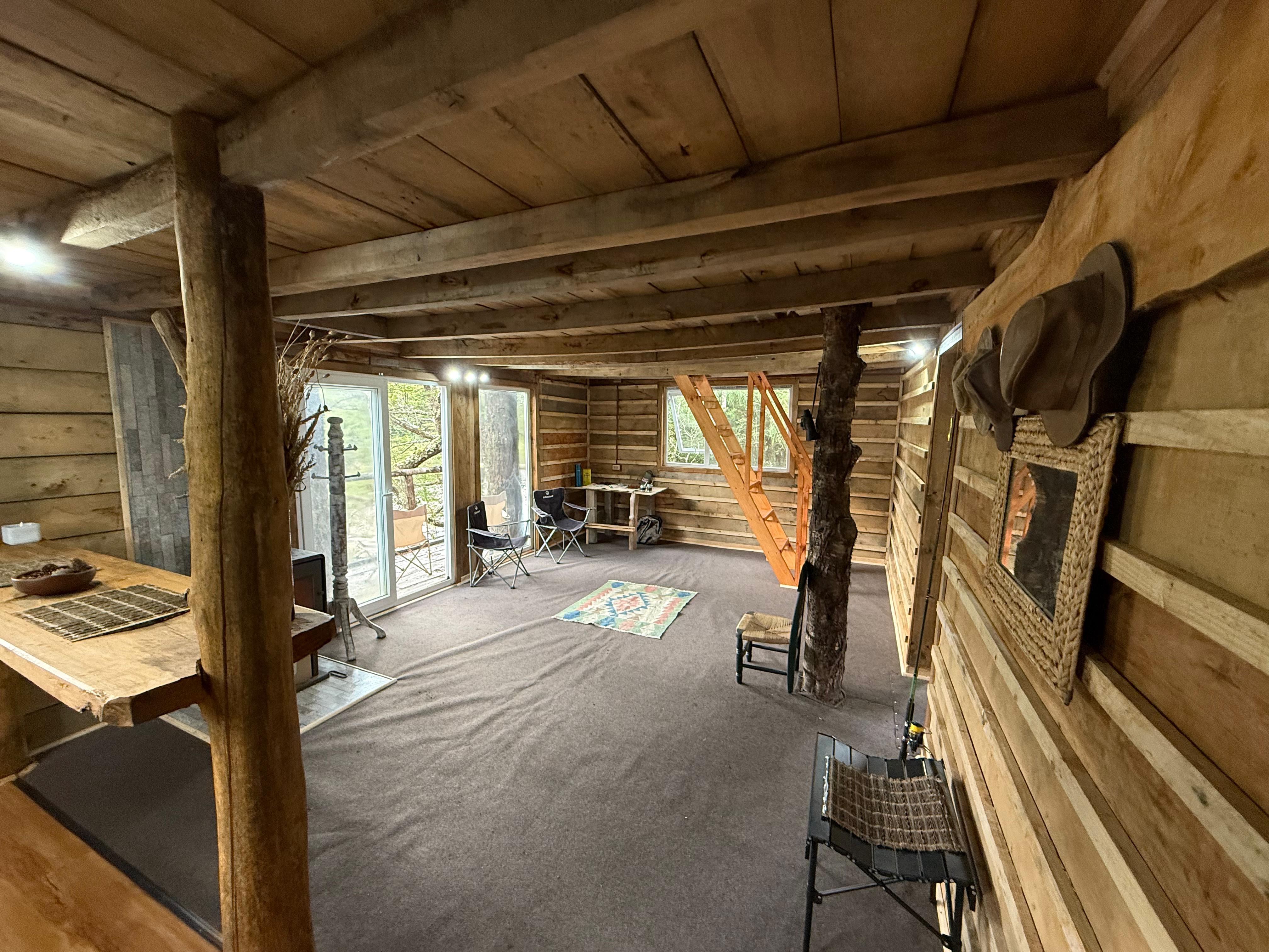 Image of the cabin with a view of the surrounding mountains